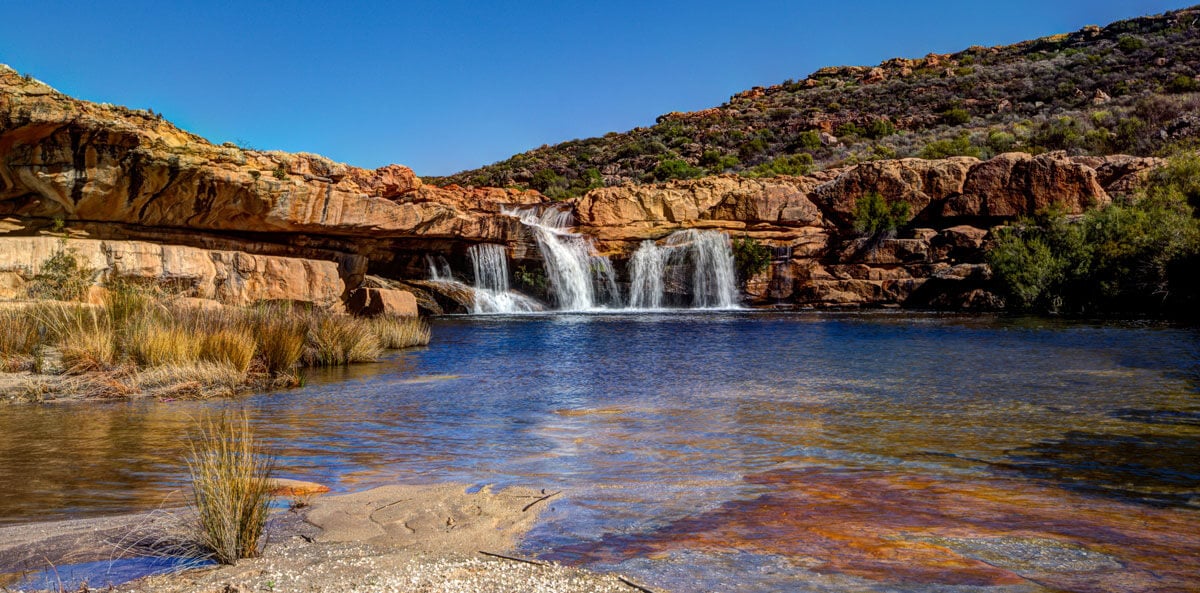 Waterfall flowing into natural rock pool